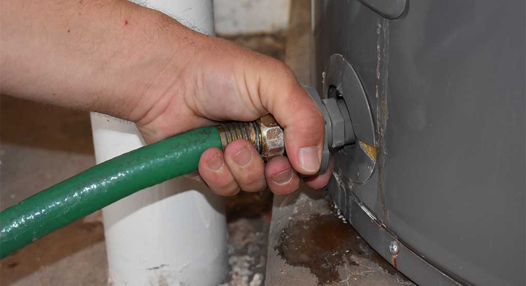 to flush a water heater, a plumber connect the hose to the drain valve